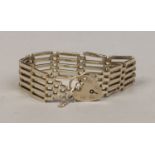 A sterling silver gate bracelet with heart shaped clasp.