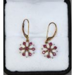 A pair of 9ct gold earrings cluster set with opals and rubies.