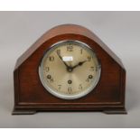 An oak cased Westminster chime mantel clock with key and pendulum by Garrard Clock Ltd England.