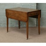 A Victorian inlaid mahogany Pembroke table raised on tapering supports.