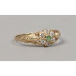 A 9ct gold floriform dress ring set with green and white stones, size Q.