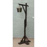 An adjustable standard lamp with leaded and stained lantern shade.