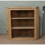 A large stripped pine corner display unit.