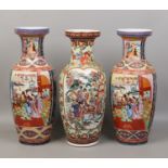 A large pair of decorative Chinese baluster vases and another similar.