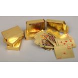 Six novelty packs of playing cards in the form of gold plated bank notes.