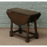 A small oak dropleaf occasional table.