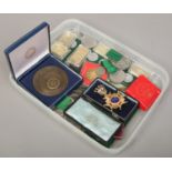 A tray of mixed coins and medals including cased enamelled medal and gold plated ingots etc.