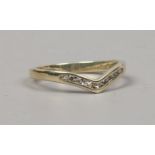 A 9ct gold channel set diamond wishbone ring size K