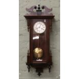 A walnut Vienna wall clock housing an eight day Junghans movement striking on a gong c1880s.