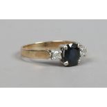 A 9ct gold sapphire and diamond three stone ring. Size M 1/2.