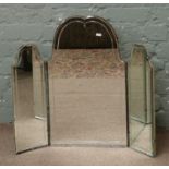 A triple dressing mirror with bevel edge and etched glass decoration.