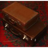 Two small vintage suitcases.