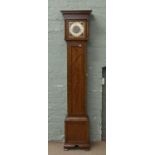 A walnut cased grandmother clock with Westminster chime.