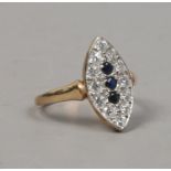 A 9ct gold navette shaped dress ring set with blue and white paste stones, size N.