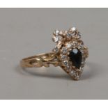 A 9ct gold dress ring the shank formed as a heart and bow, size O.