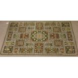 A green ground multi square design rug,