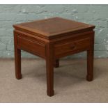 A Chinese hardwood single drawer table.