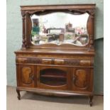 A carved walnut mirror back sideboard raised on ball and claw feet.