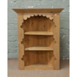 A small stripped pine corner display unit.