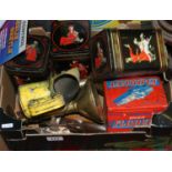 A box of miscellaneous to include vintage tins, brass candlesticks,