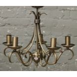 A brushed brass five branch ceiling light fitting no shades.