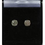 A pair of diamond stud earrings. Each round cut stone approximately 1ct.