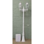 A white painted garden light in the form of a Victorian two branch street light.