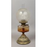 A Victorian brass based oil lamp with frosted glass shade.