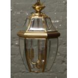 A brass and bevel edge glass three branch hall lantern.