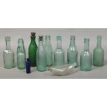 A collection of vintage glass storage bottles mainly beer bottles from local breweries.