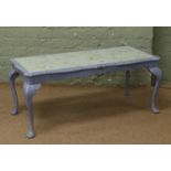A painted glass top coffee table raised on cabriole supports