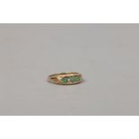 A 9ct gold dress ring set with emeralds, size O.