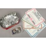 A tin of mixed coins medals and transport tokens,