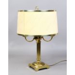 A brass reeded column table lamp with cream circular shade.