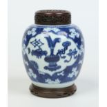 An 18th century Chinese ginger jar with associated pierced hardwood cover and stand.