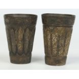 A near pair of antique Persian silvered metal goblets of conical fluted form decorated with