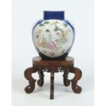 An 18th century Chinese ginger jar and cover on associated hardwood stand.