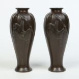 A pair of Japanese Meiji period patinated bronze vases of reeded baluster form.