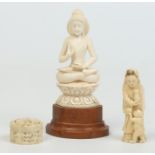 Three 19th century ivory carvings including an Indian figure of a meditating Buddha,