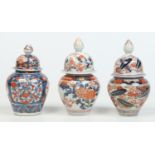 Three Japanese late 17th / early 18th century Imari baluster shaped jars and covers,