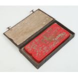 A large Chinese red ink stone in fitted case.