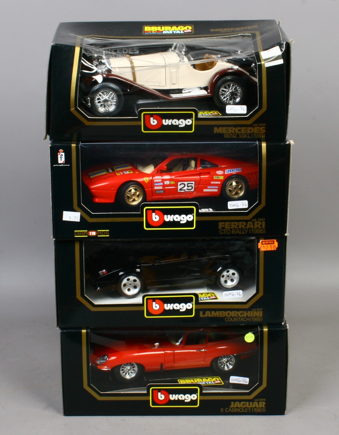 Four boxed Burago 1/18 scale model Diecast cars including Mercedes, Ferrari, Lamborghini and Jaguar.