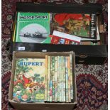 Three boxes of books and magazines including 1970s Rupert annuals, 1950s Motor Sport magazines etc.