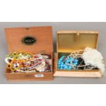 Two boxes of costume jewellery including beads, necklaces, bracelets etc.