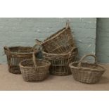 A collection of vintage potato picker baskets.