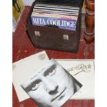 A carry case of L.P records including Phil Collins, Shakin Stevens, Cliff Richard etc.