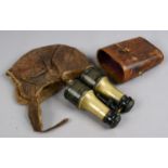 A leather fur lined flying cap along with a pair of brass binoculars for theatre,