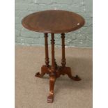 A walnut occasional table raised on tripod base with centre finial.
