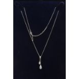 A cased 18ct white gold diamond set negligee pendant.