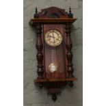 A Victorian mahogany cased Kienzle eight day wall clock with enamel dial chiming on a coiled gong